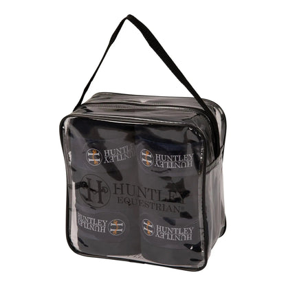 Clear travel bag with black handles containing Huntley Equestrian products on a white background