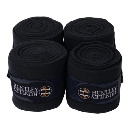 Four rolls of black Huntley bandage on a white background