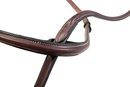 Close-up of a brown leather bridle on a white background