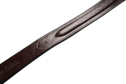 Brown leather belt with engraved design on a white background