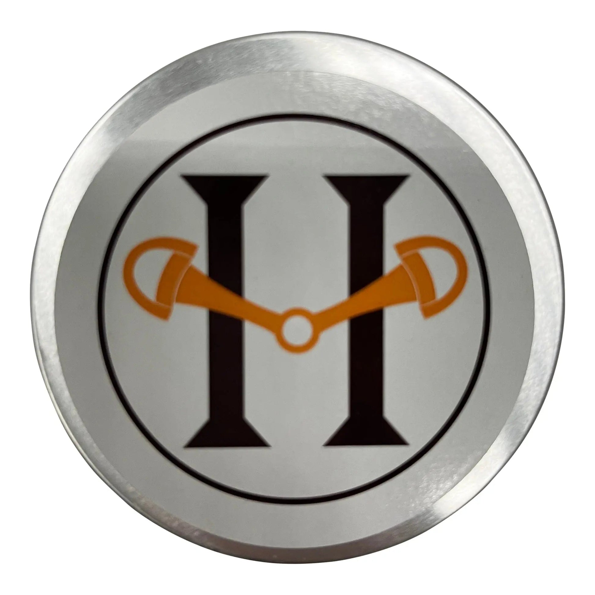 Circular metal badge with a logo featuring a stylized 'H' with orange accents on a white background