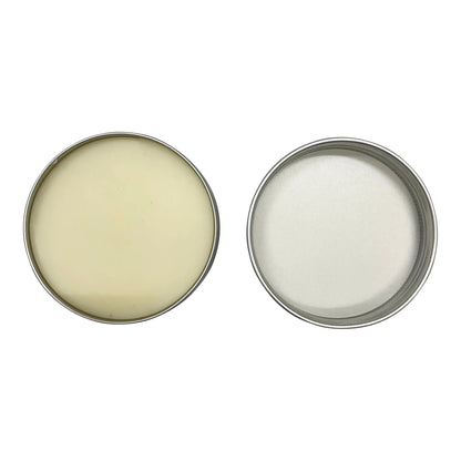 Two metal tins with cream-like contents on a white background