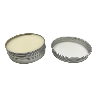 Two metal containers with lids, one filled with a white substance on a white background
