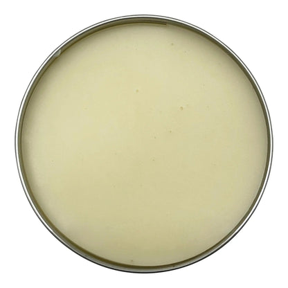 Round container of cream on a white background
