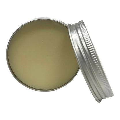 Open metal tin with a lid on a white background