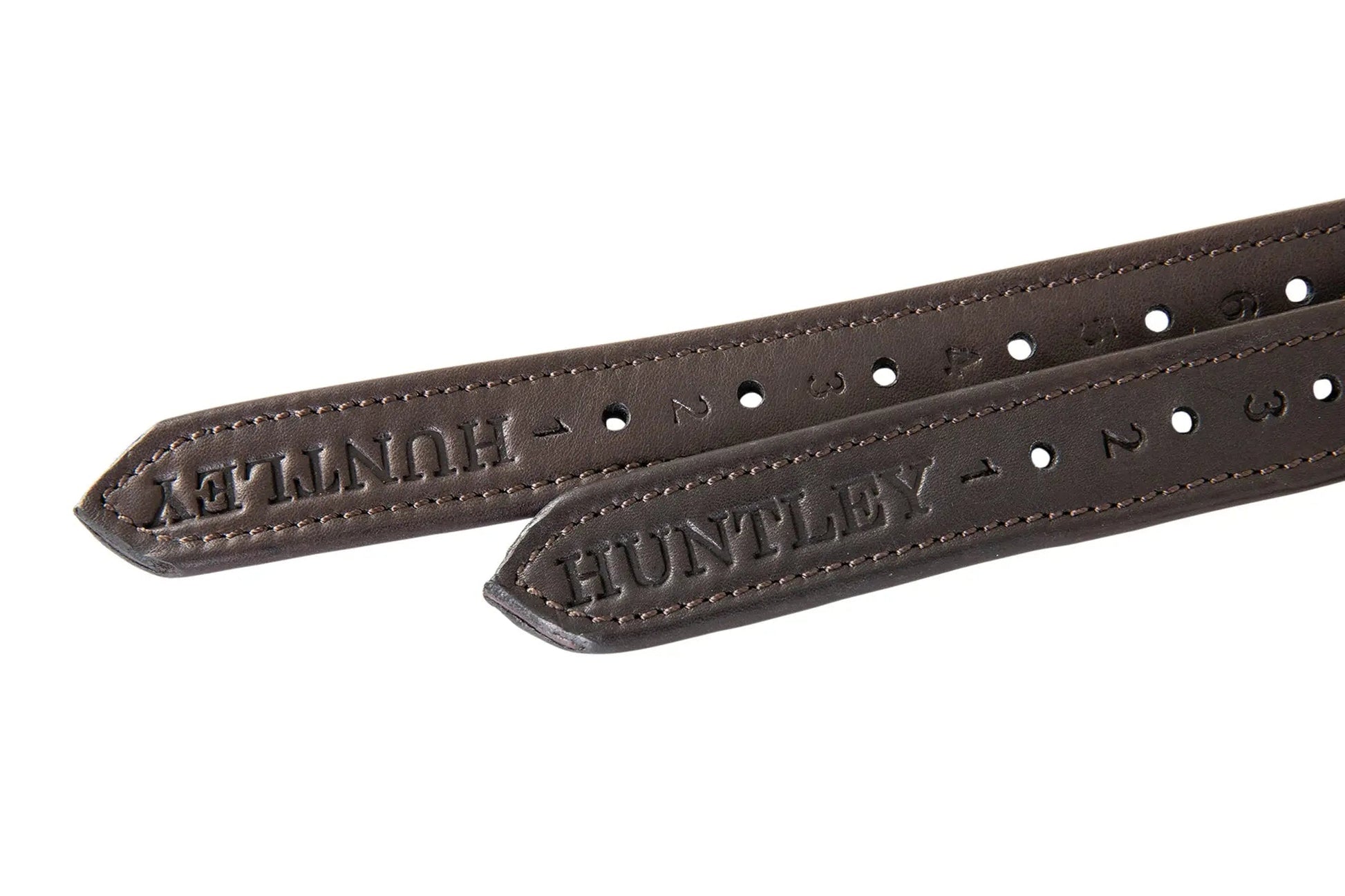 Two brown leather straps with embossed text on a white background
