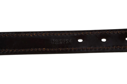 Close-up of a black leather belt with visible stitching on a white background