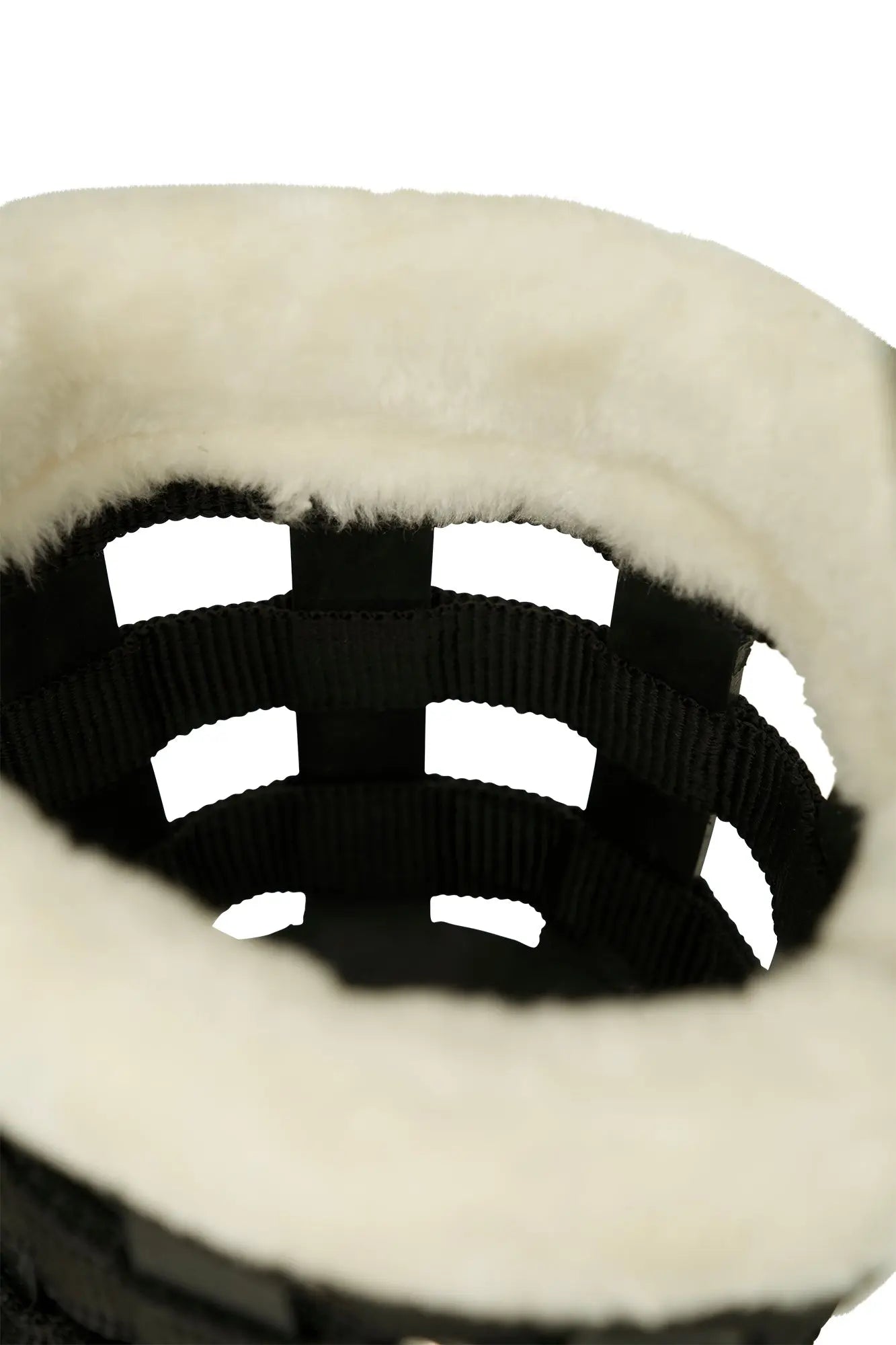 Close-up of a black and white patterned sweater with a fluffy beige background