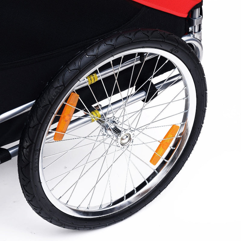 Close-up of a bicycle wheel with orange reflectors on a white background