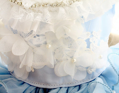 Close-up of a decorative headband with white flowers and pearls on a blue background