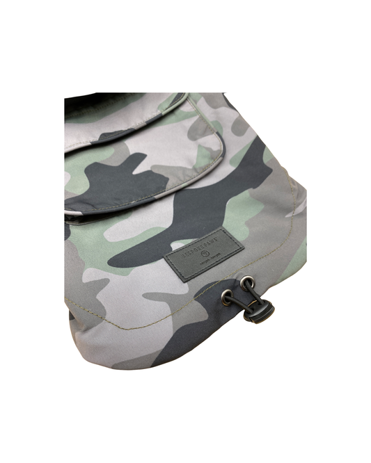 Camouflage-patterned bag with a visible brand label on a white background