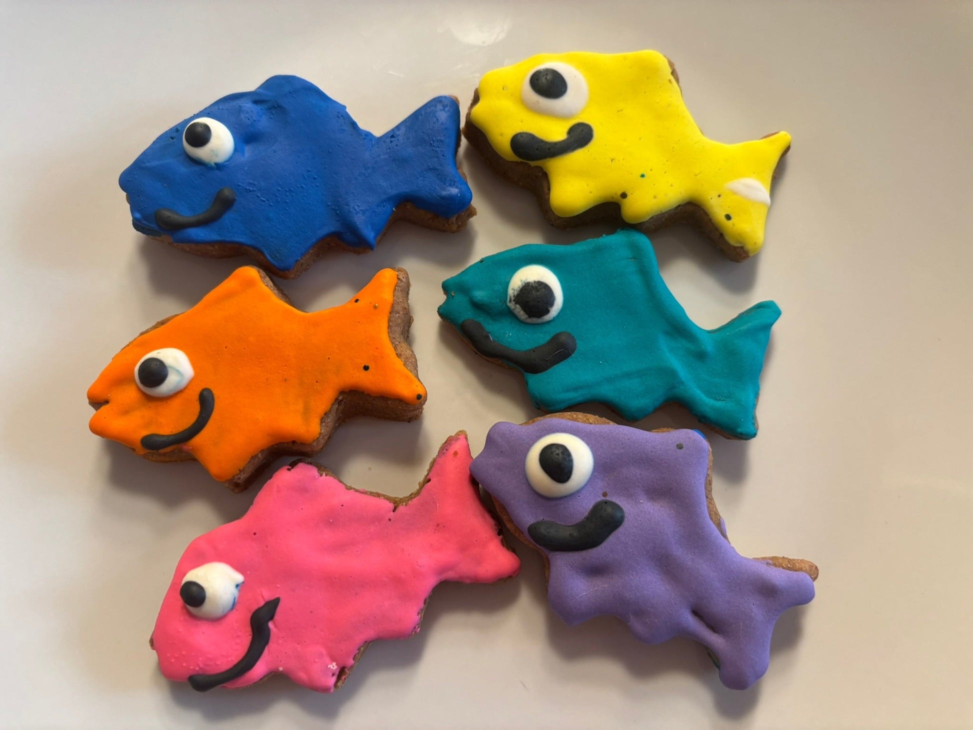 Colorful fish-shaped cookies on a light background