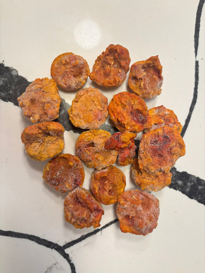 Dried apricots arranged on a white surface with black lines