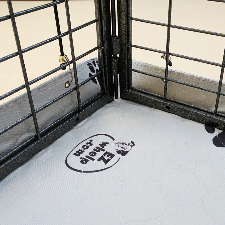 Corner of a room with wire mesh flooring and a logo on the floor.