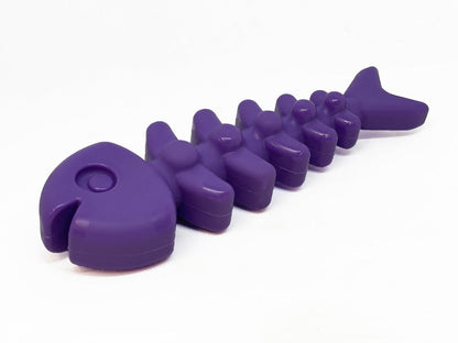 Purple dog toy shaped like a fish on a white background