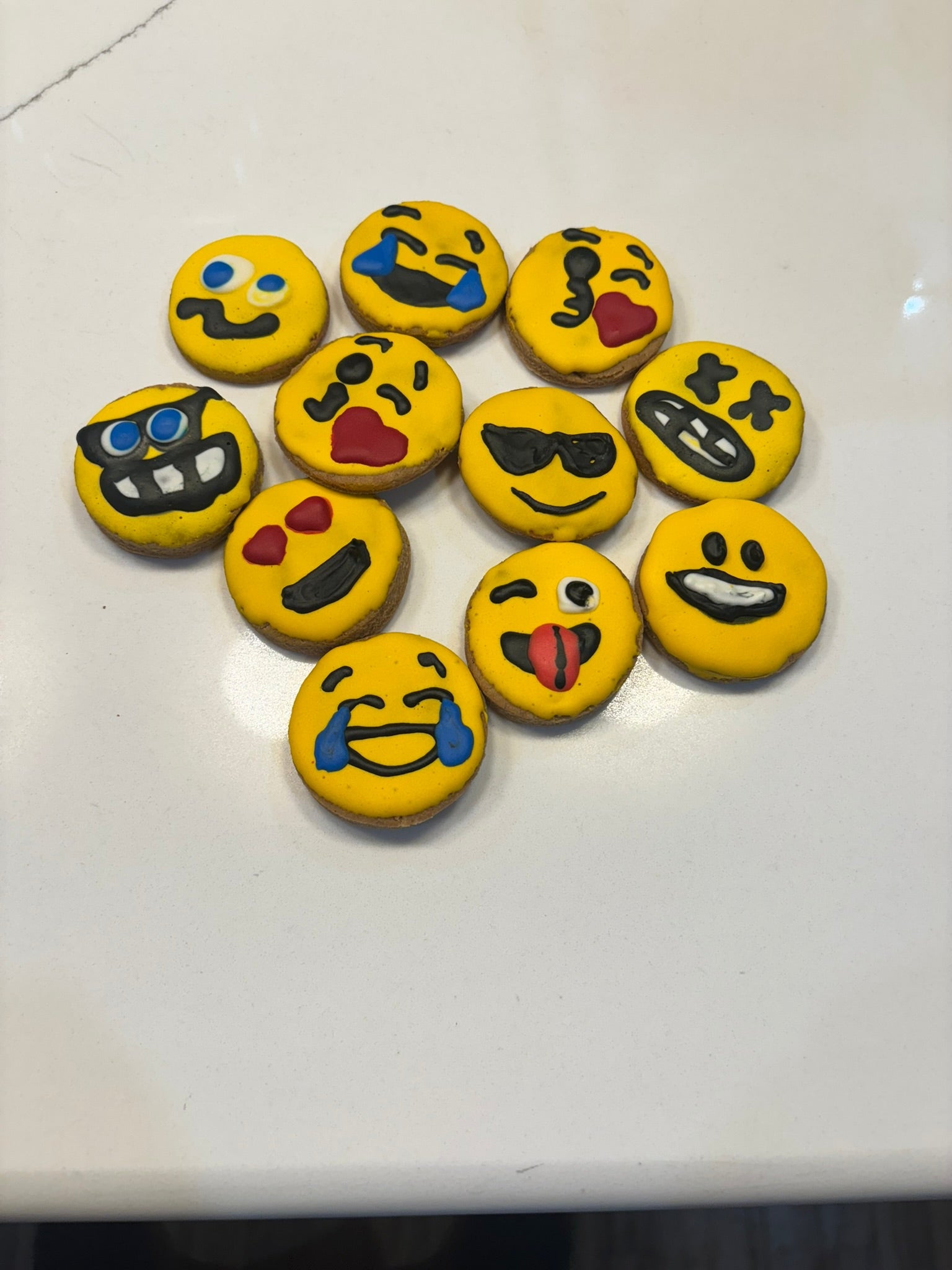 Set of emoji-themed cookies on a white surface