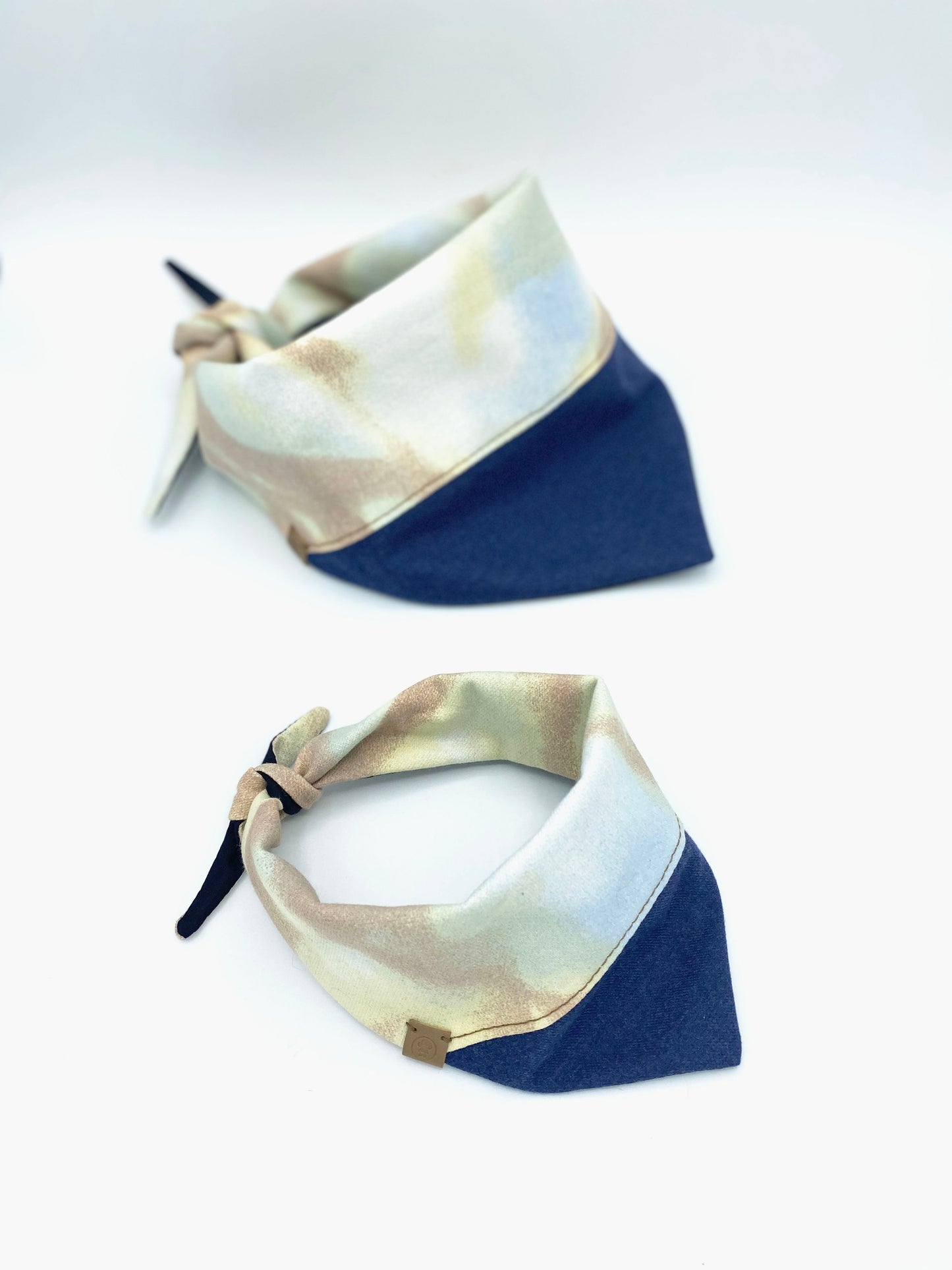 Two bandanas with a beige and blue pattern on a white background