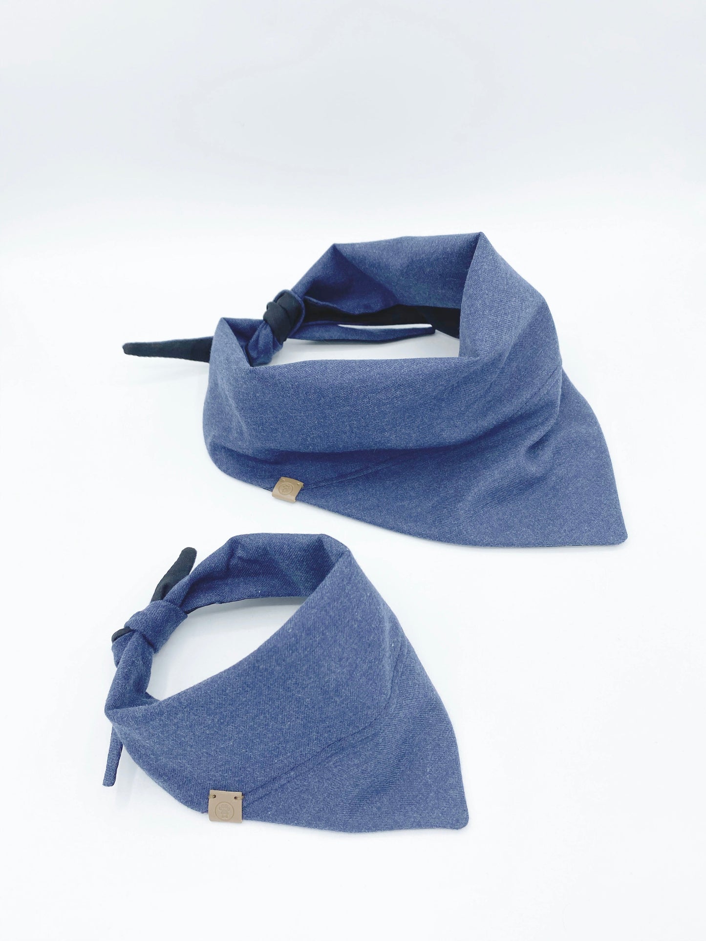 Two blue pet bandanas on a white background