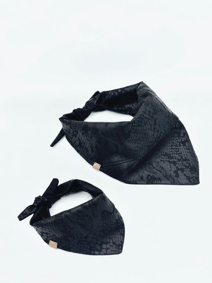Two black patterned bandanas on a white background