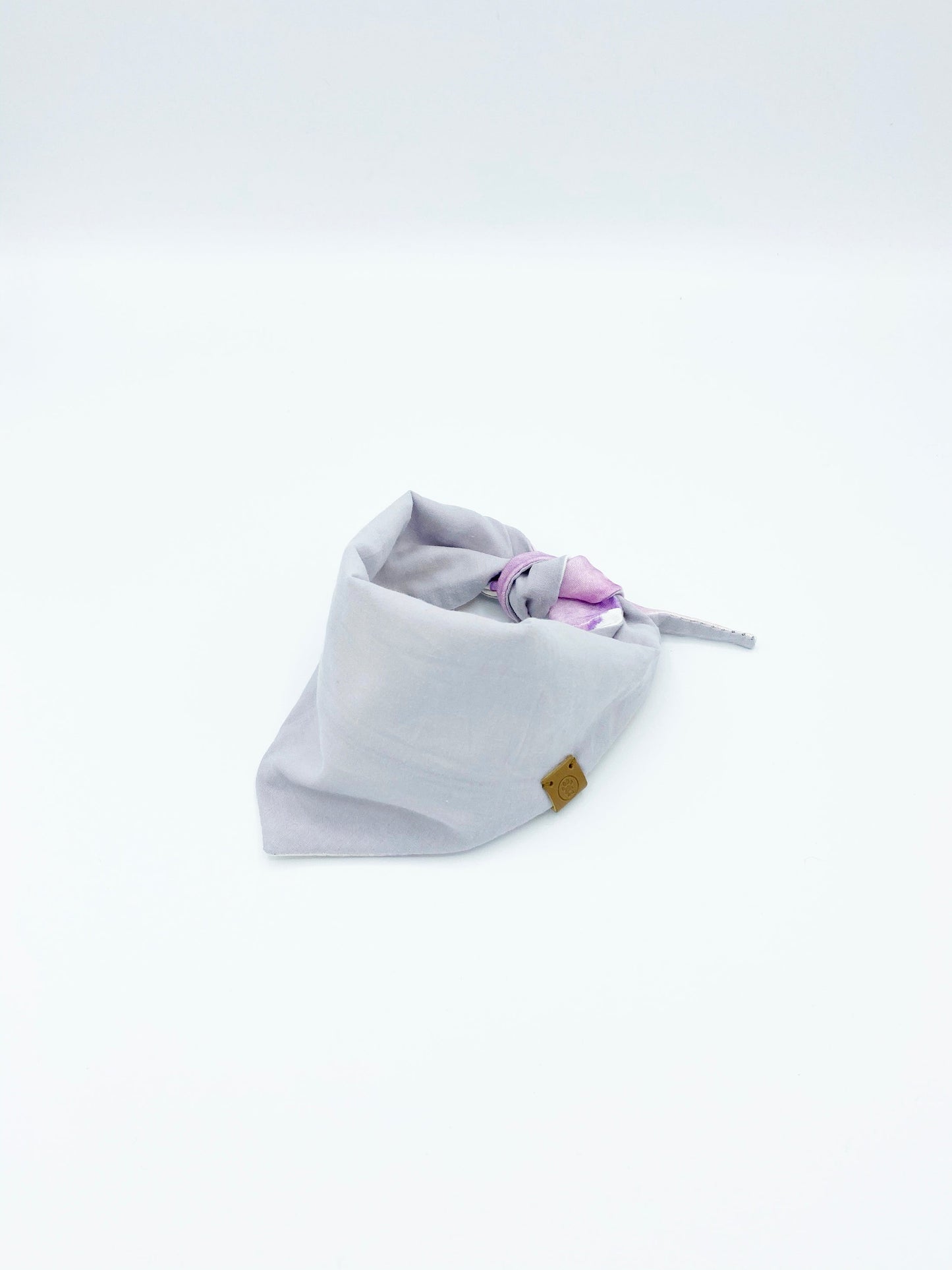 Baby bandana bib with purple accents on a white background