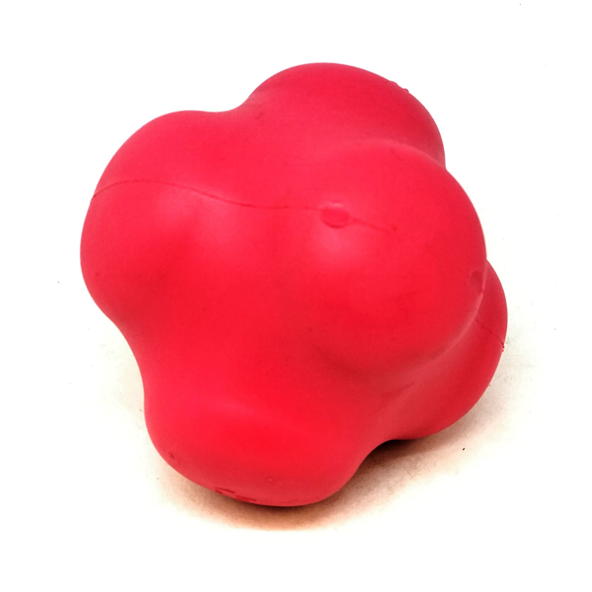 Red dog toy shaped like a heart on a white background