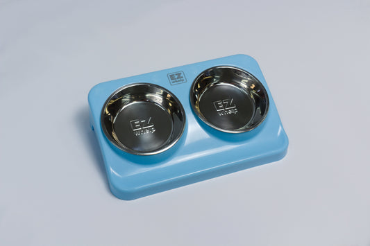 Blue pet bowl stand with two stainless steel bowls on a gray background