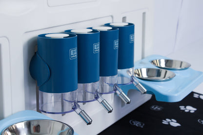 Pet feeding station with blue water dispensers and metal bowls on a white wall.