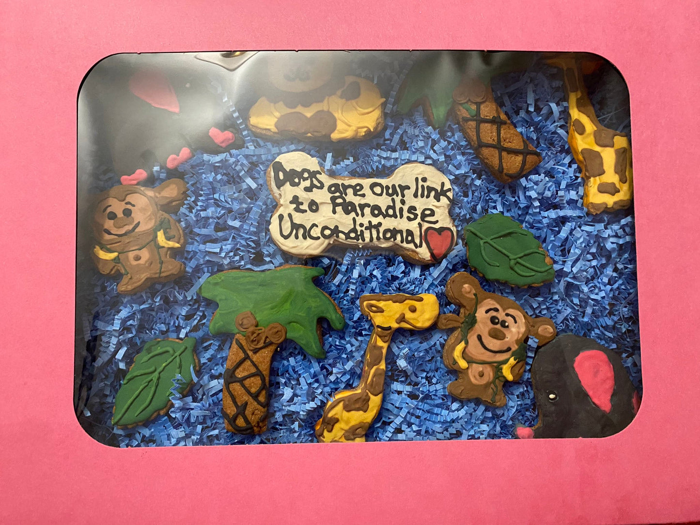 Decorative tray with animal figurines and a quote on a pink background