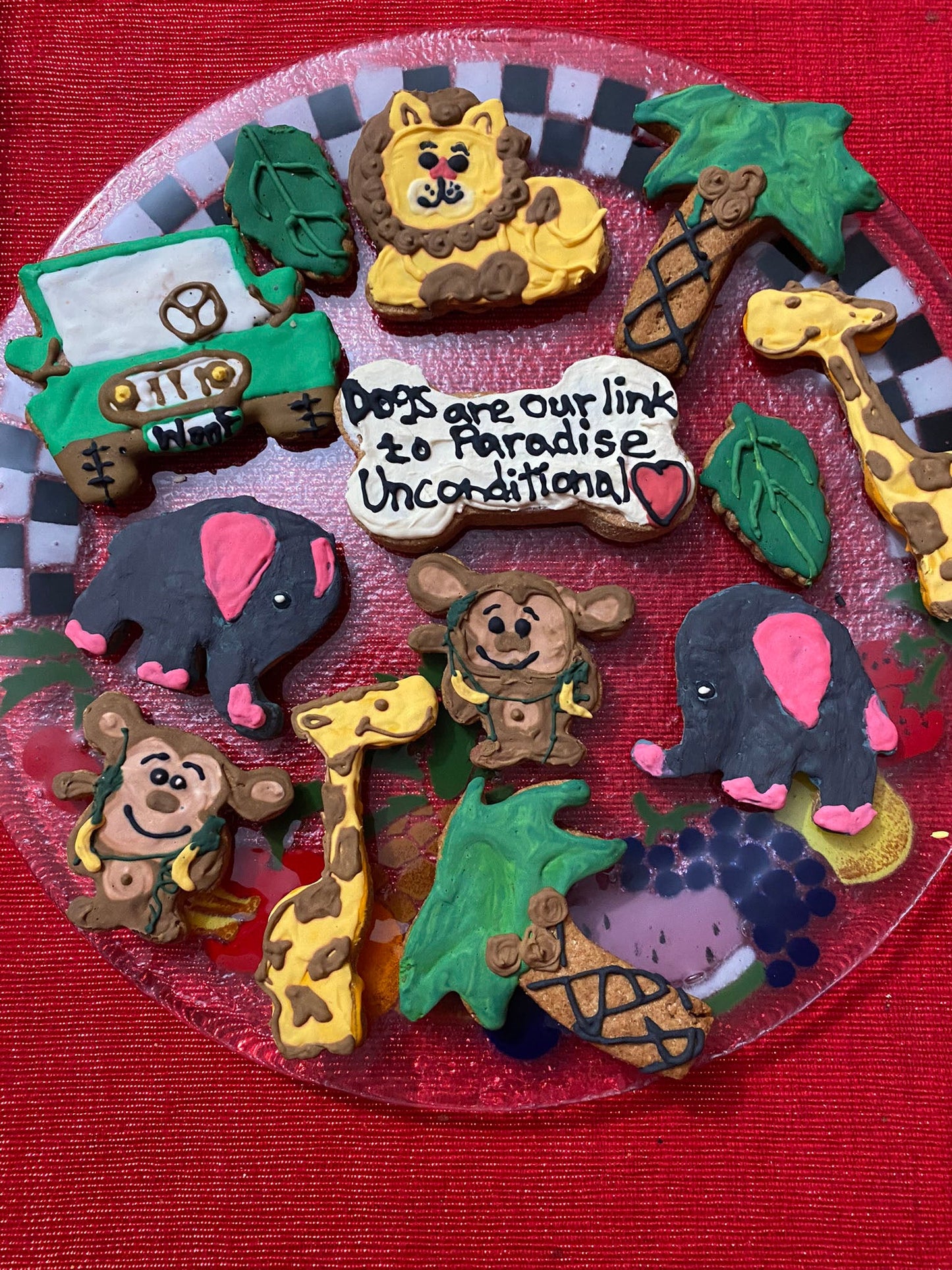 Collection of animal-themed cookies on a red plate with a checkered border