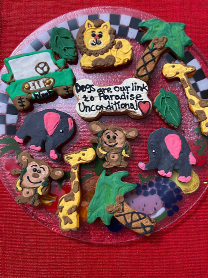 Collection of animal-themed cookies on a red plate with a checkered border