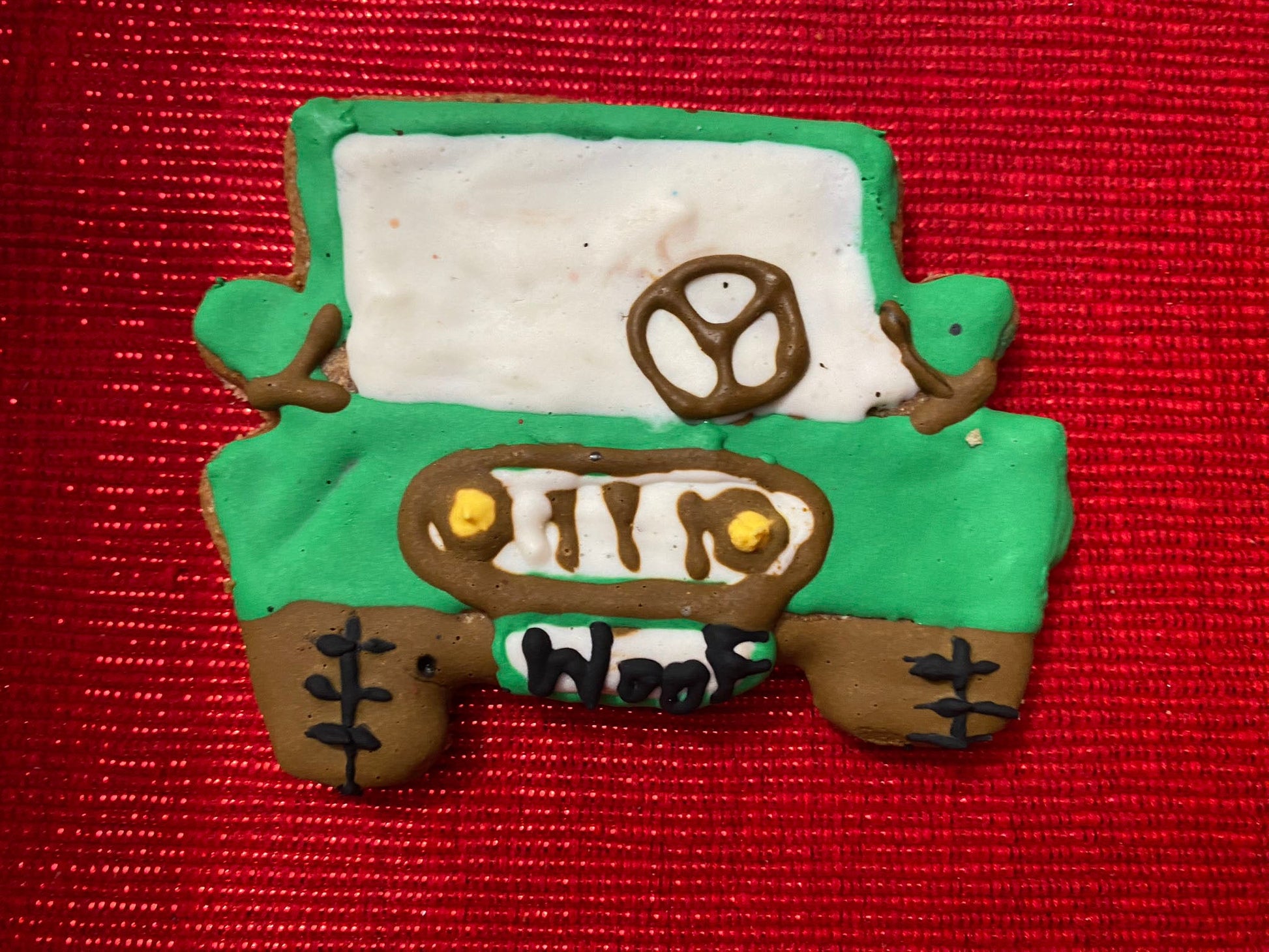 Green toy truck cookie with white interior on a red background