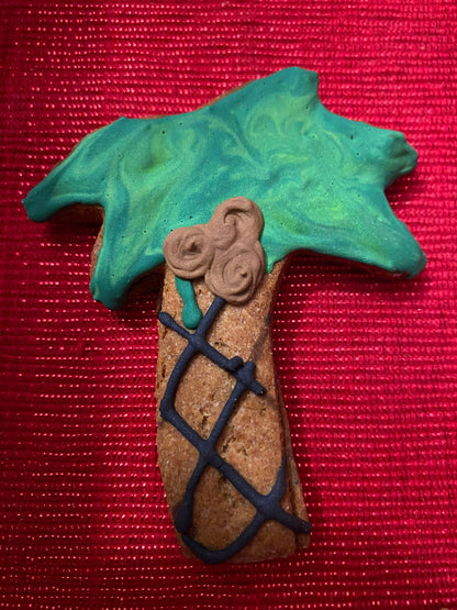 Decorative item resembling a cross with green top and brown base on a red background