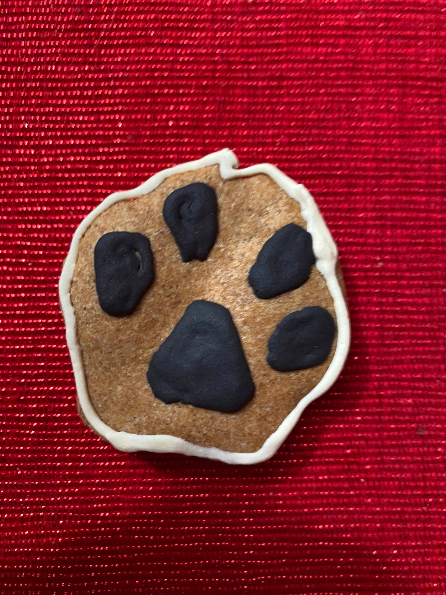 Dog paw print cookie on a red background