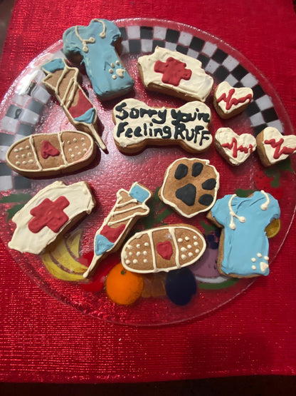 Decorative cookies shaped like medical supplies and a paw print on a red background