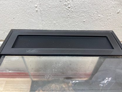Black metal screen on a glass surface with a concrete wall background