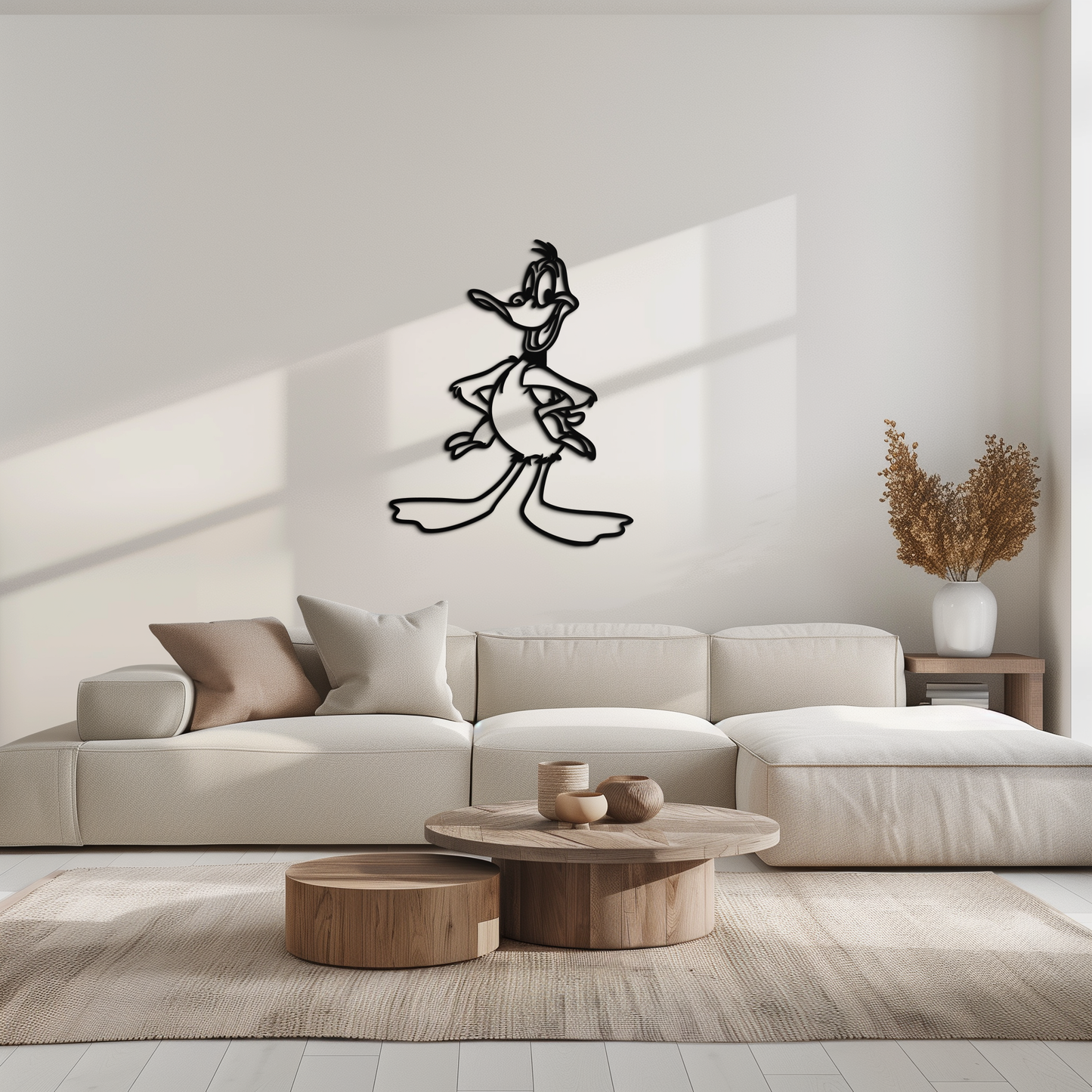 Modern living room with a beige sofa, wooden coffee table, and wall decal of a cartoon character.
