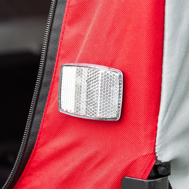 Close-up of a reflective safety patch on a red jacket with a blurred background
