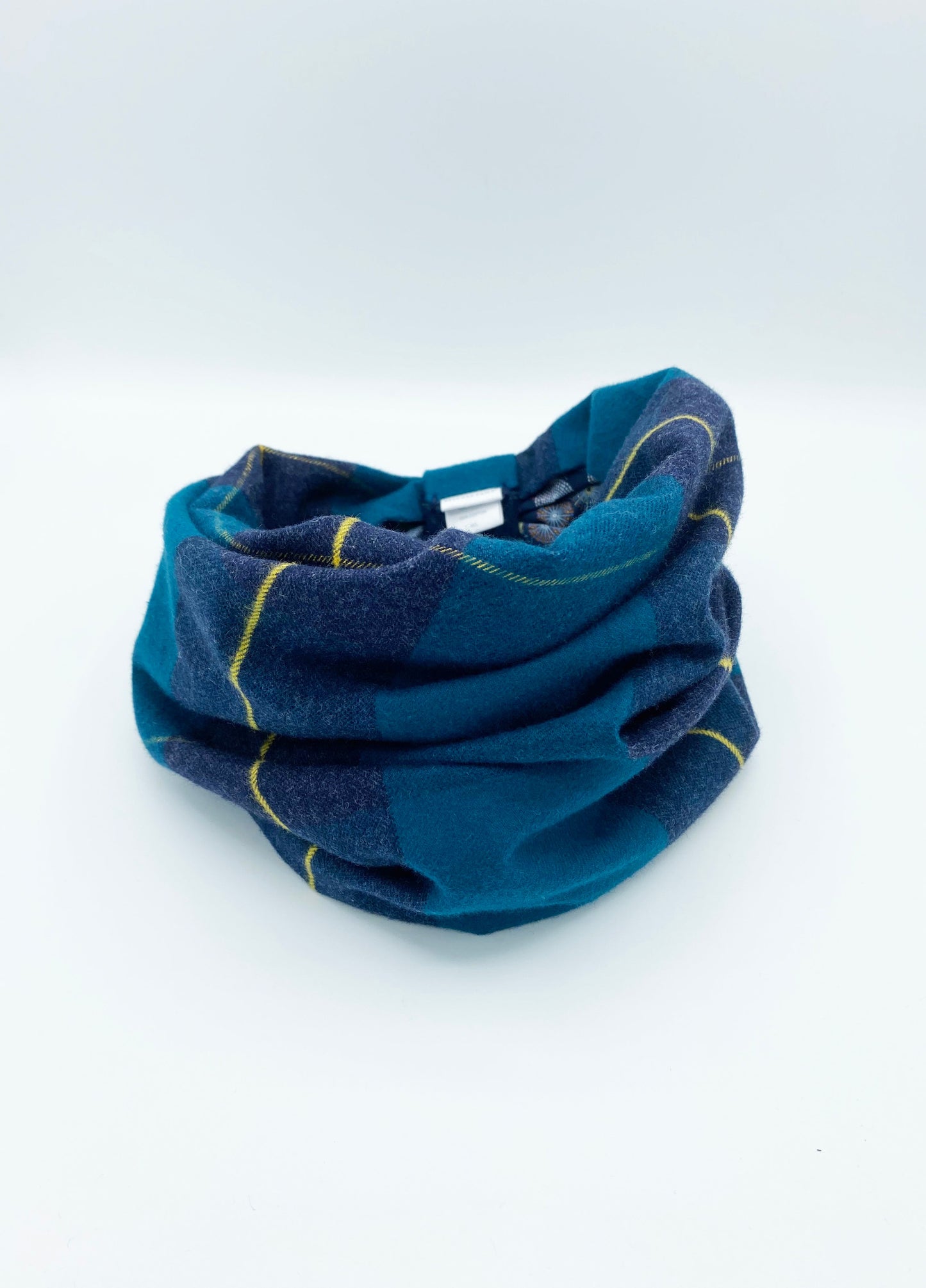 Blue neck gaiter with yellow accents on a white background