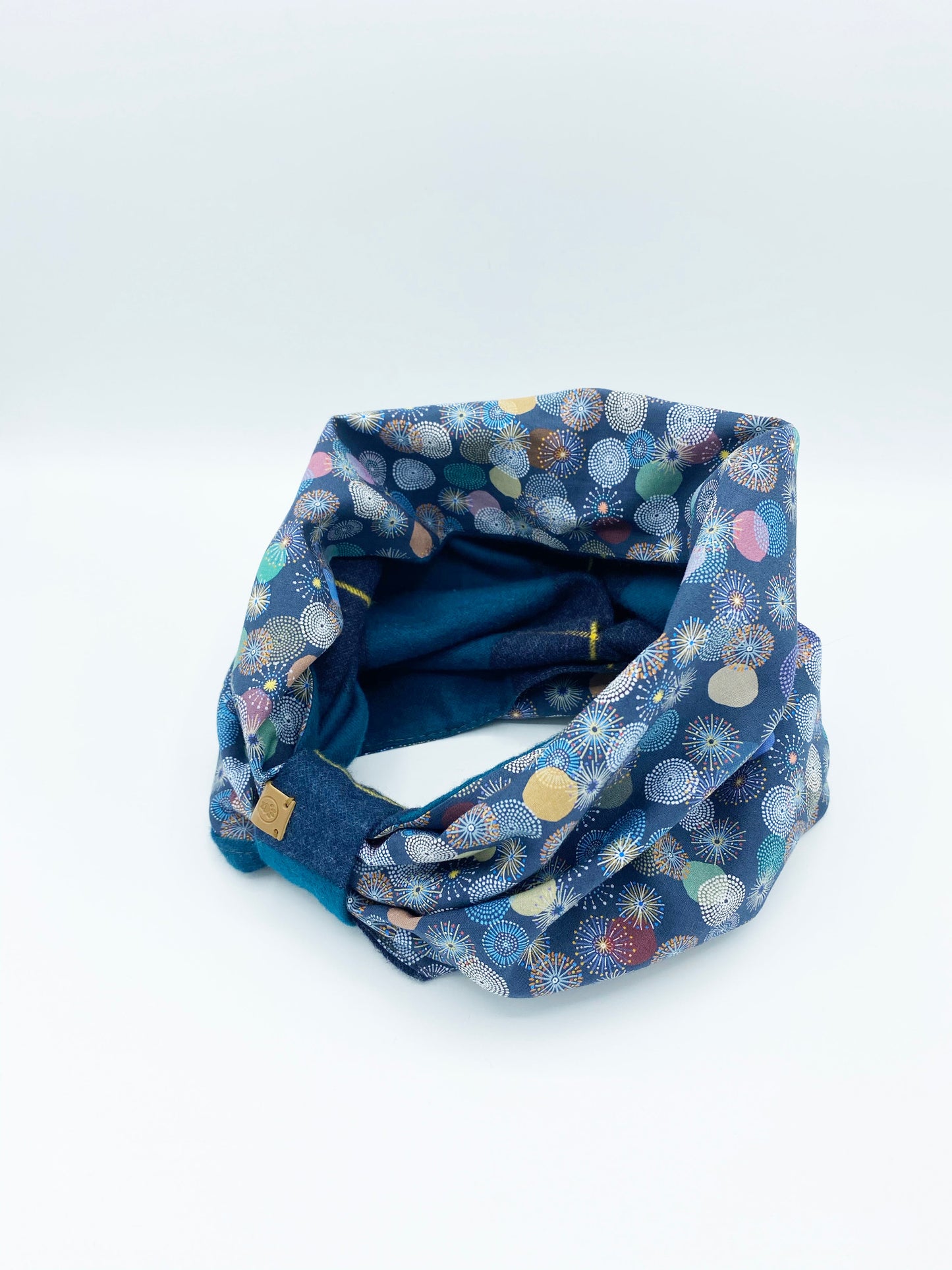 Blue patterned fabric tube on a white background