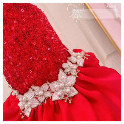 Red sequined headpiece with pearl and crystal decorations on a neutral background