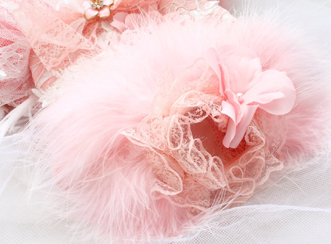 Close-up of a pink tulle skirt with floral details on a white background