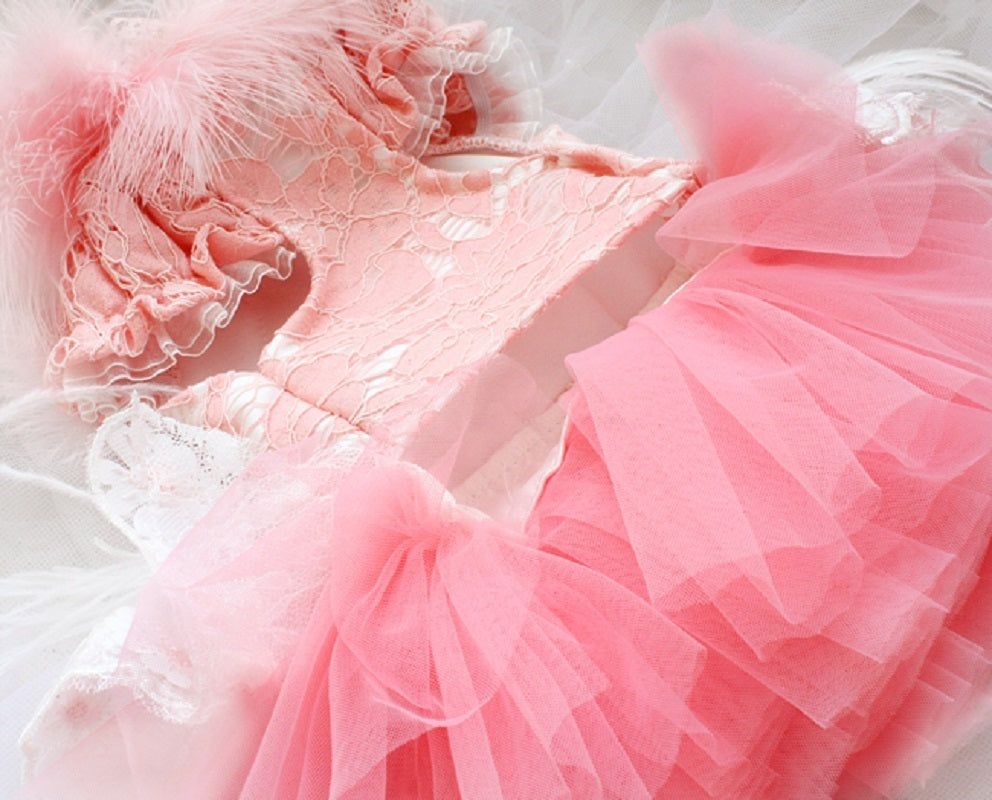 Close-up of a pink dress with ruffled layers on a light background