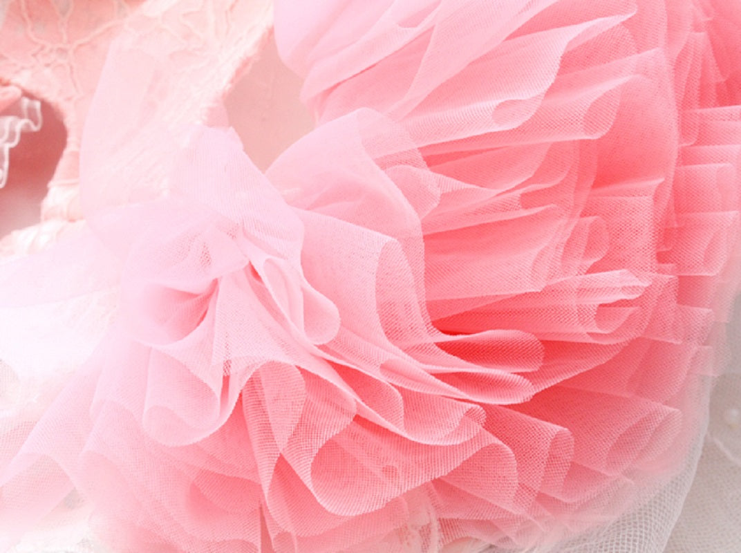 Close-up of a pink tulle fabric with a soft focus background