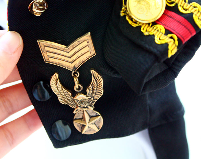 Close-up of a military uniform with insignia and decorations.