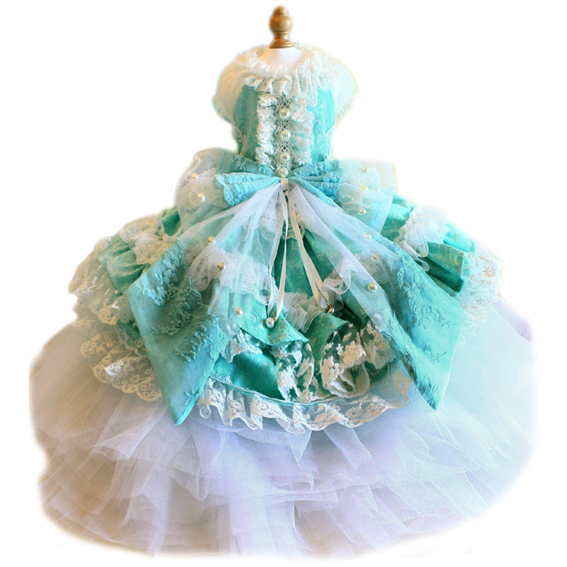 Turquoise and white dress on a mannequin with a white background