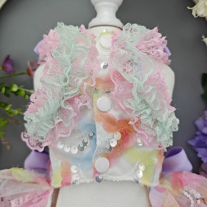 Pastel-colored floral dress on a mannequin with sequins and lace details.