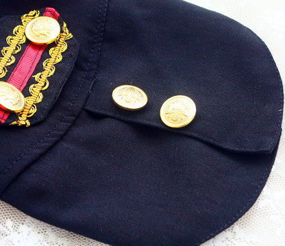 Navy blue cap with gold buttons and decorative elements on a white background