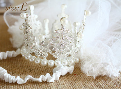 Pearl headband with intricate design on a textured surface