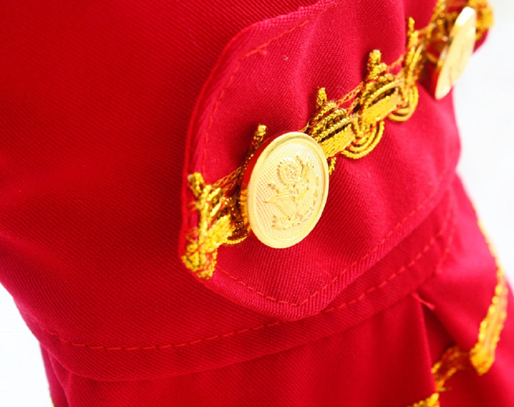 Close-up of a red garment with gold embroidery and buttons.