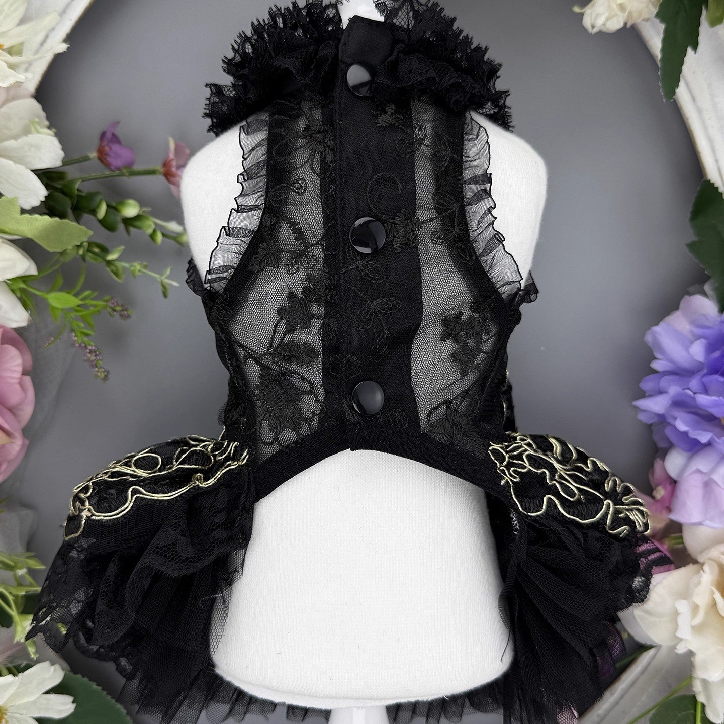 Black lace dress on a mannequin with floral decorations